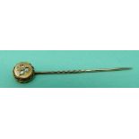 A 15ct gold stick pin set with three diamonds