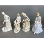 Four Nao figures including boy with lamb, girl with kitten,