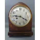 An oak mitre cased c1930 two train mantel clock with Arabic dial raised on bun feet,