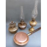 Three vintage brass and copper oil lamps together with a copper bed pan