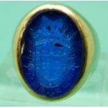 A yellow metal ring marked 14k set with a blue glass intaglio, 12.