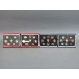 Four Royal Mint deluxe cased coin collections comprising 1983, 1984,