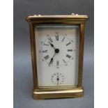 A French corniche cased brass carriage clock with strike and alarm facility and Roman enamel dial