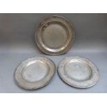 Three 18thC pewter plates, two having touch marks,