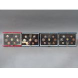 Four Royal Mint deluxe cased coin collections comprising 1983, 1984,