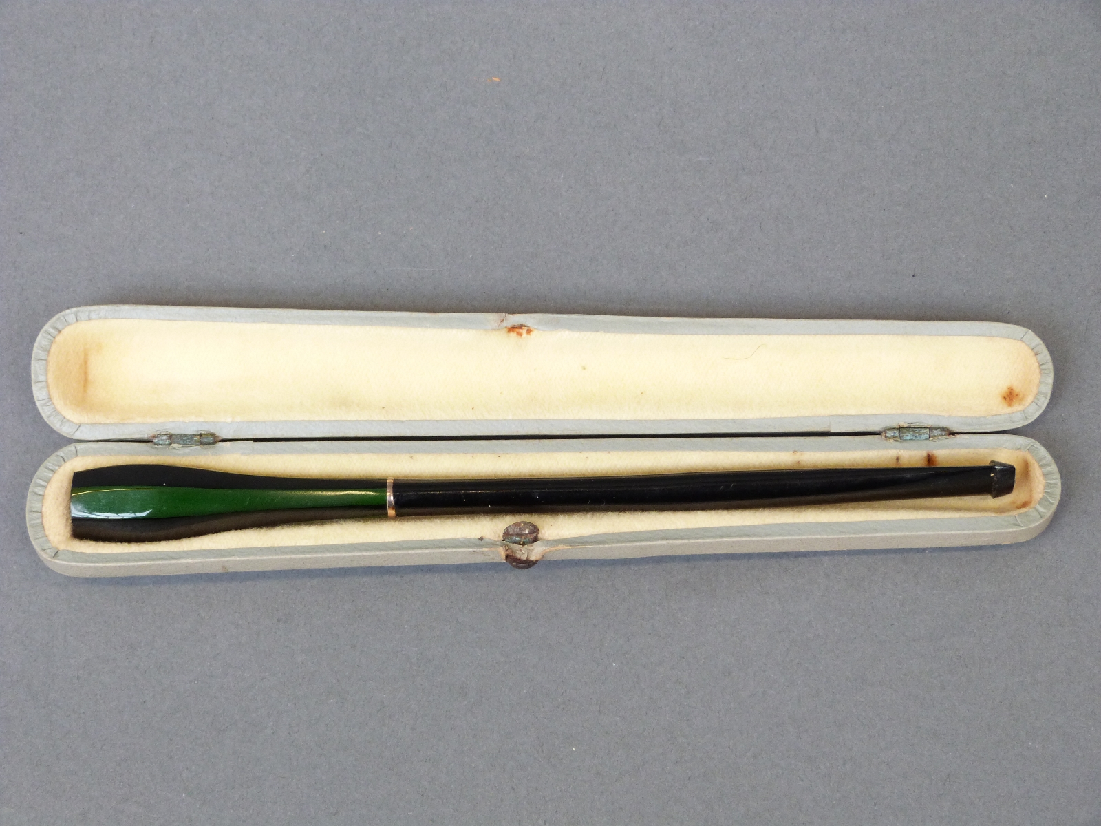 A flash overlaid cut glass cheroot holder with black stain over green ground and yellow metal