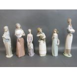 A collection of Lladro figurines including girls in gowns and with flowers
