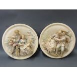 A pair of ceramic relief figural plaques