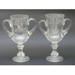 A pair of clear glass trophy/urn shaped glass celery vases with etched decoration,