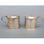 Two Edward VII hallmarked silver mustards, one with blue glass liner,