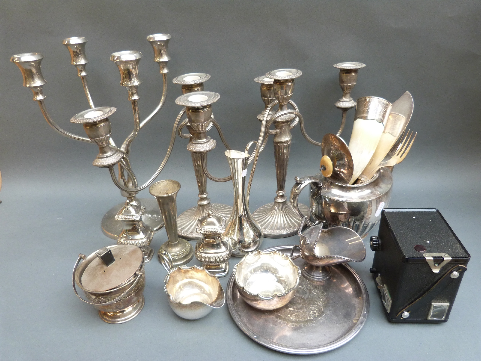 A collection of plated ware including candleabras, one with four branches; tray, fish servers,