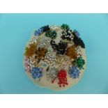 A collection of beaded brooches