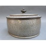 An oval Tudric pewter dressing table pot with hammered decoration, width 14.