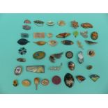 A collection of brooches to include enamel floral examples, wooden brooch,