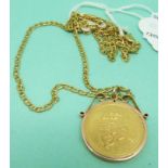 A 9ct gold pendant set with an Arabic coin on a 9ct gold chain,