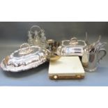 A collection of silver plated items including entree dishes, four-bottle cruet,