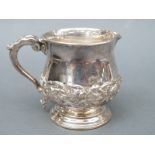 An Edward VII hallmarked silver pedestal cream jug with embossed floral decoration, Chester 1908,