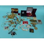 A collection of jewellery to include a shell necklace, silver necklaces, silver bracelet, brooches,