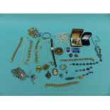 A collection of costume jewellery including a 9ct gold brooch, silver brooch,