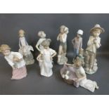 A collection of Nao child figures including boy with puppy, girl with goose,