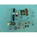 A collection of costume jewellery to include brooches, necklaces,