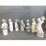Nao figures including dog in morning dress, Spanish girl, boy and girl,