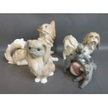 Four larger Lladro dog figures including poodles with ball