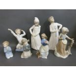 A collection of Nao child figures including girl with butterfly