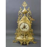 A French gilt matel clock with two train movement striking on a bell, with key,