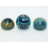 Three Mdina glass paperweights one signed by the artist to the base,