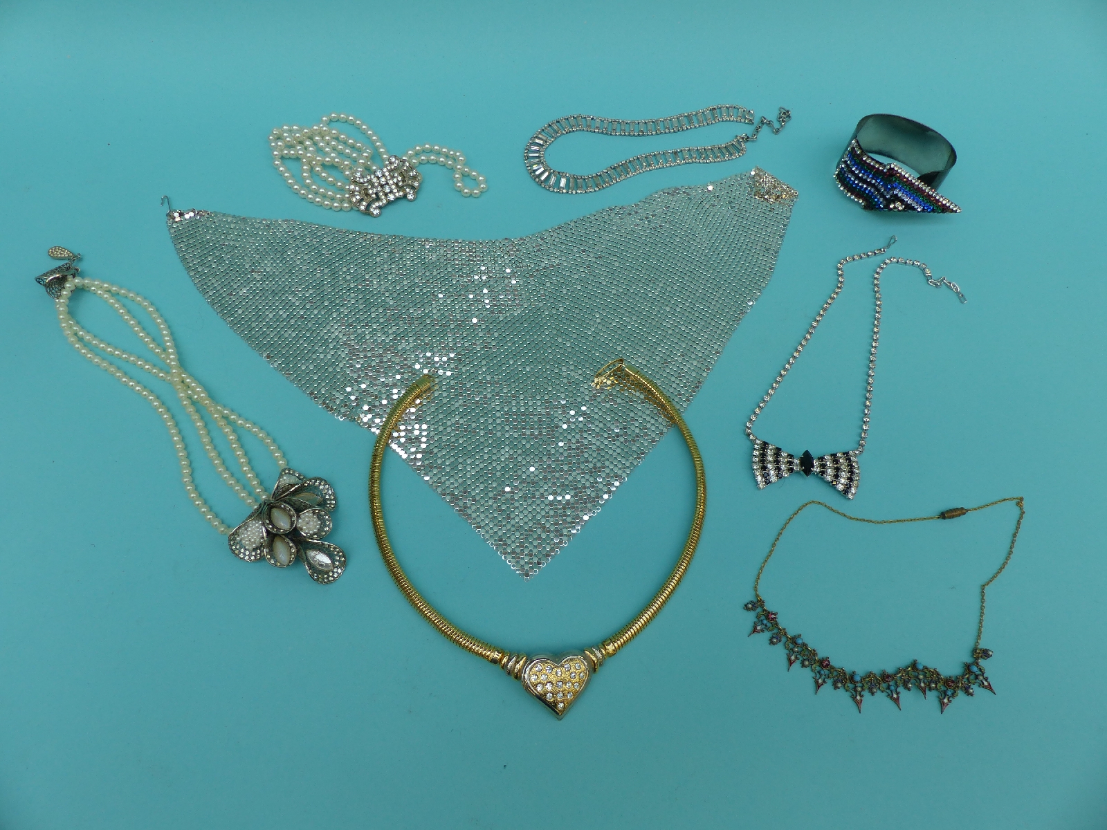 A collection of costume jewellery including an enamel and silver diamante necklace