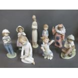 A collection of Nao child figures including boy with cake,
