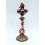 A gilt metal and flash overlaid glass lamp,