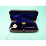 A 15ct gold stud and a 15ct gold stick pin set with a diamond in original box