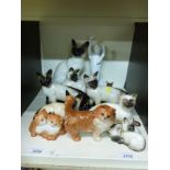 A collection of Beswick and Royal Doulton cat models,