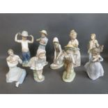 Nao figures including father and baby, boy with wide brimmed hat,