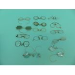 A collection of early spectacles/glasses including tortoiseshell, coloured lenses, gold,