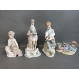 Four Lladro figures featuring boys with dogs and lambs