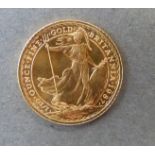 A 1987 gold ten pound miniature 1/10 oz Britannia