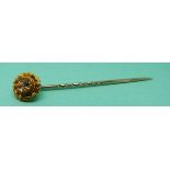 A 15ct gold stick pin set with a sapphire and two diamonds