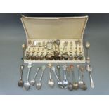 A collection of white metal and plated collectors' spoons,