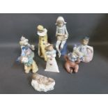 A collection of Nao figures including several clown examples,