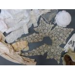 A quantity of early 20thC textiles to include kid mourning gloves,