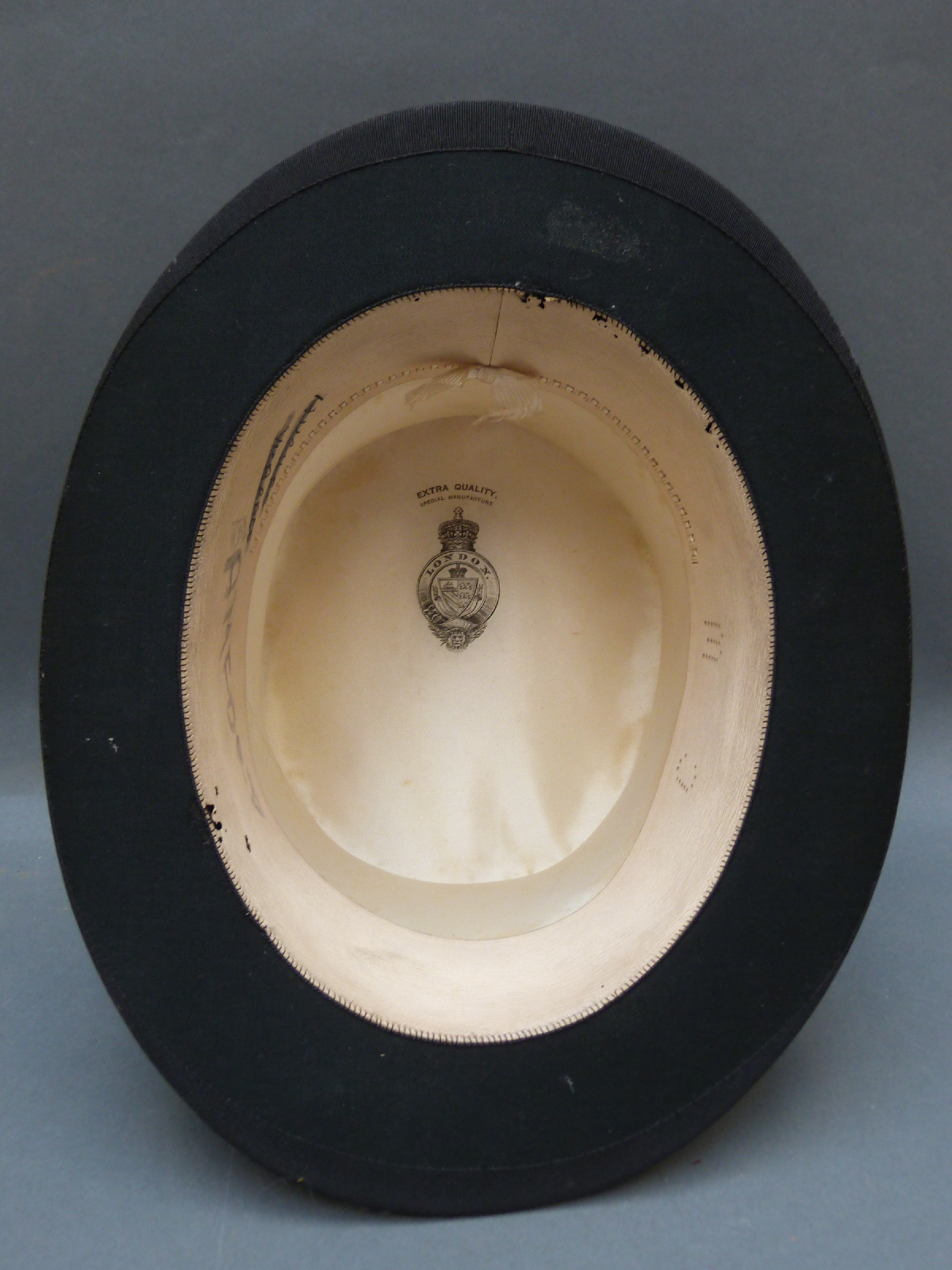 A black silk top hat, internal size approimately 20cm x 16cm.