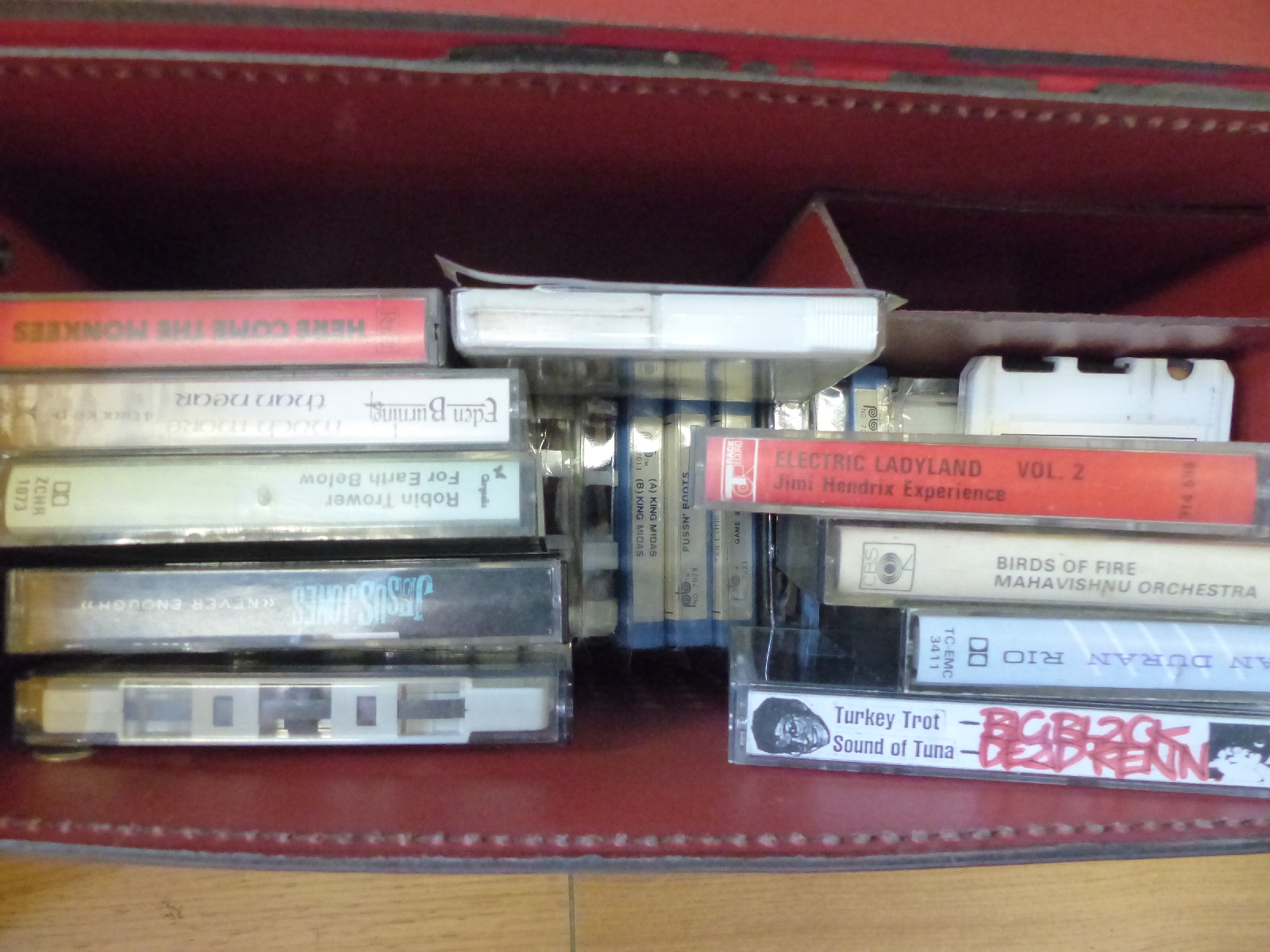 A collection of various reel to reel and cassette tapes includes jazz