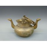 A bronze or brass twin handled pouring kettle probably Benin,