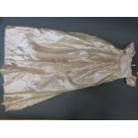 A collection of late 19th/early 20thC child's clothing to include ivory silk coats,