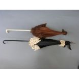 Two 19th Century parasols to include a late Victorian example in mourning colours with black ribbon