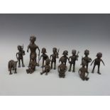 A group of thirteen African brass figures depicting hunting, mother and child,
