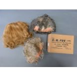 Three theatrical wigs in a box by C. H .